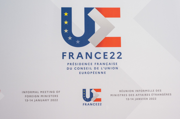 Ein Plakat mit dem Text "Frankreich 22 - Inoffizielle Tagung der Außenminister" und dem Logo der Europäischen Union, das ein blauer Kreis mit einem weißen Rand, ein weißer Stern in der Mitte und ein weißer Rand ist.